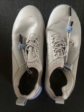 Women’s White Slip-On Sneakers with Light Blue Accents